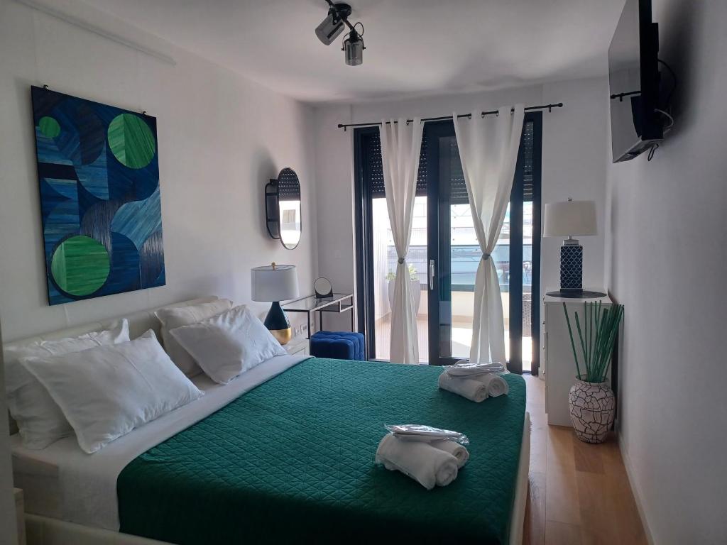 um quarto com uma cama grande e um cobertor verde em Apartment Gabi em Zadar