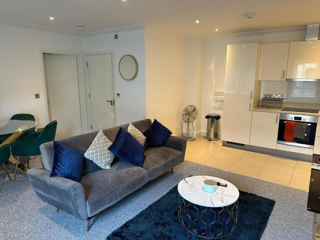 a living room with a couch and a table at Cromwell Court Apartments in Huntingdon