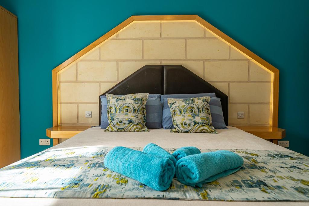 Postel nebo postele na pokoji v ubytování Il-Logga Boutique Hotel