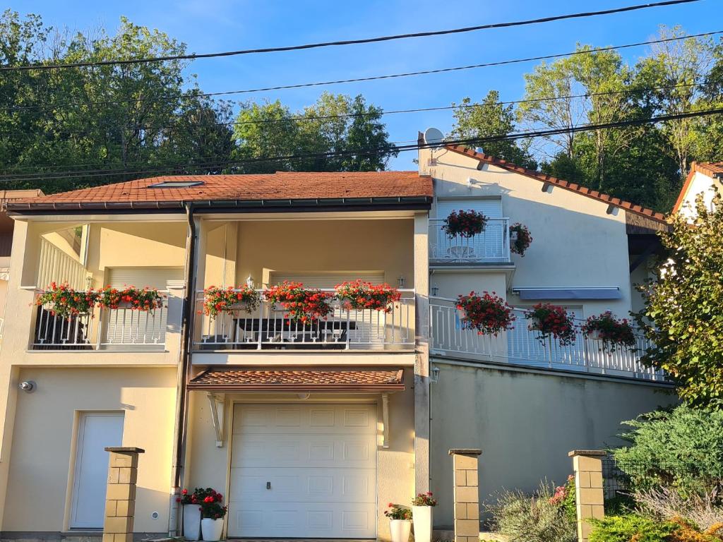 a house with flower boxes on the balconies at GITE DE CHARME in Changey