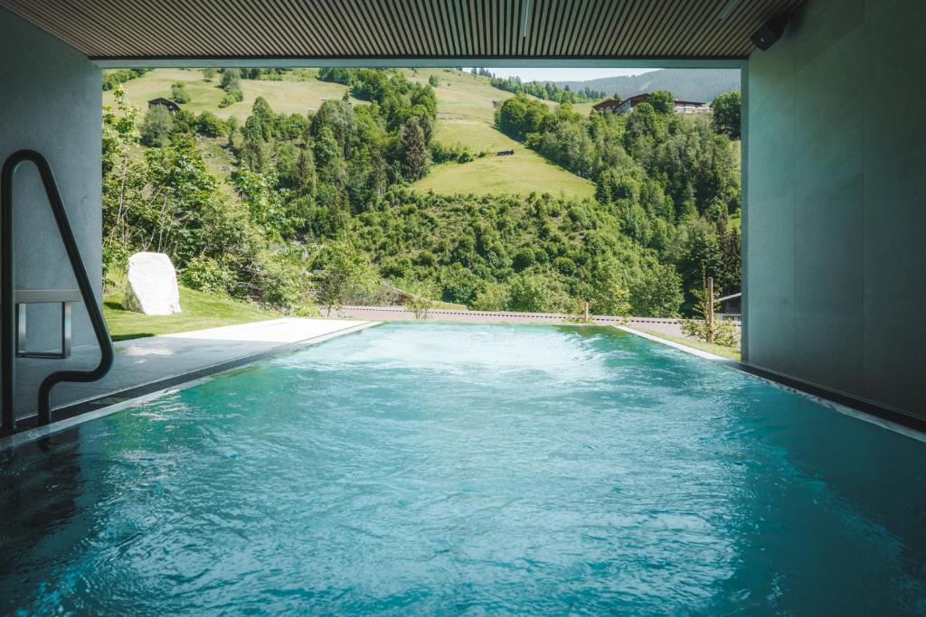 a swimming pool with a view of a mountain at Haus Jausern in Saalbach Hinterglemm