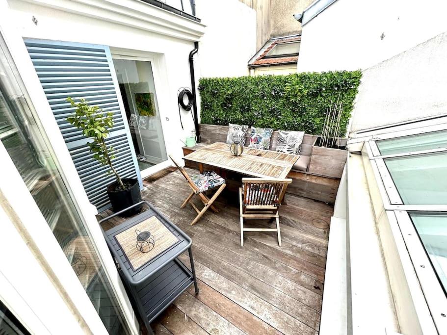 a small patio with a table and chairs on a balcony at Rare Parisian Architect House in Paris