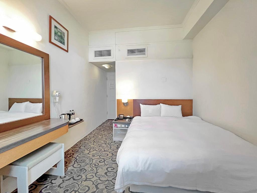 Postel nebo postele na pokoji v ubytování Foung Kou Hotel
