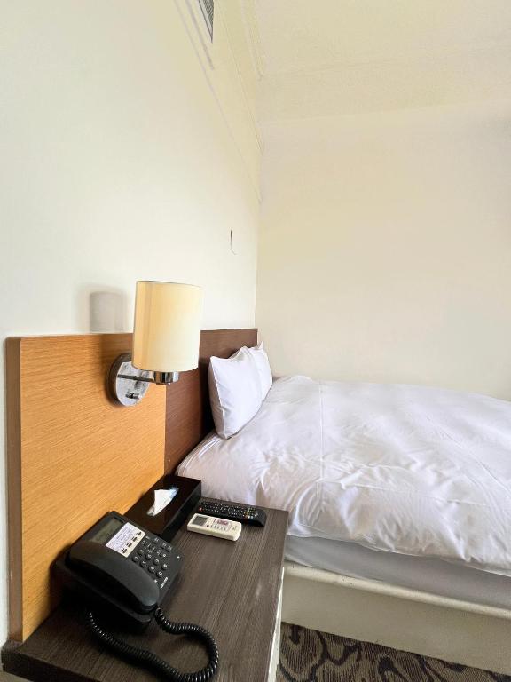 Postel nebo postele na pokoji v ubytování Foung Kou Hotel