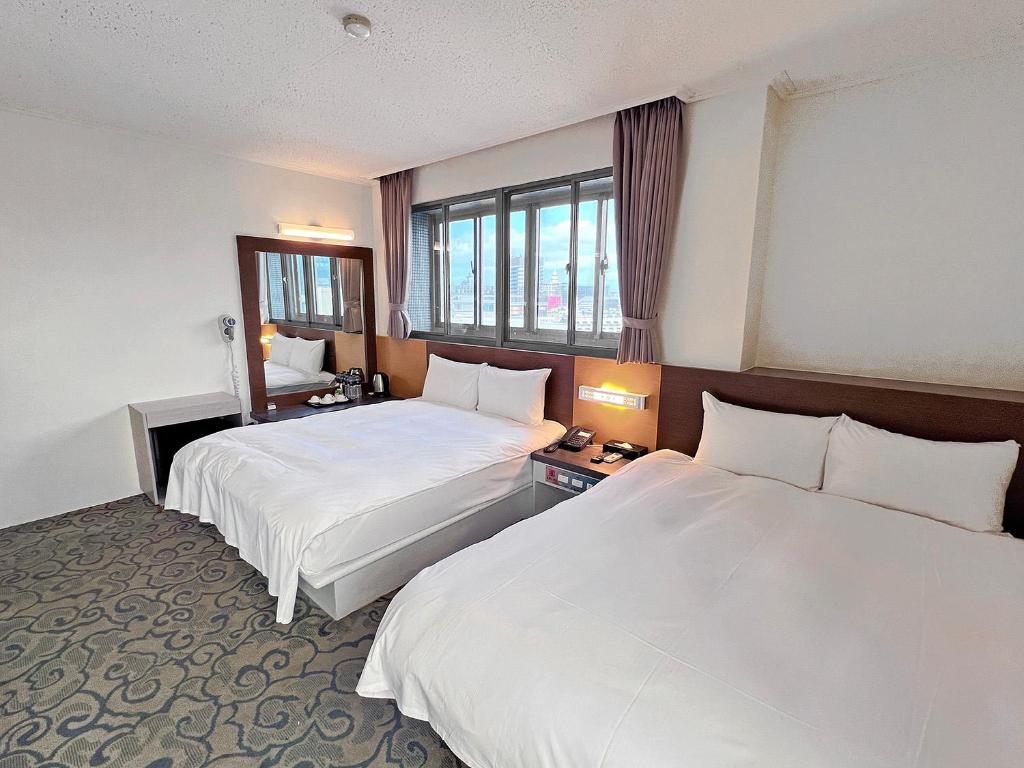 Postel nebo postele na pokoji v ubytování Foung Kou Hotel