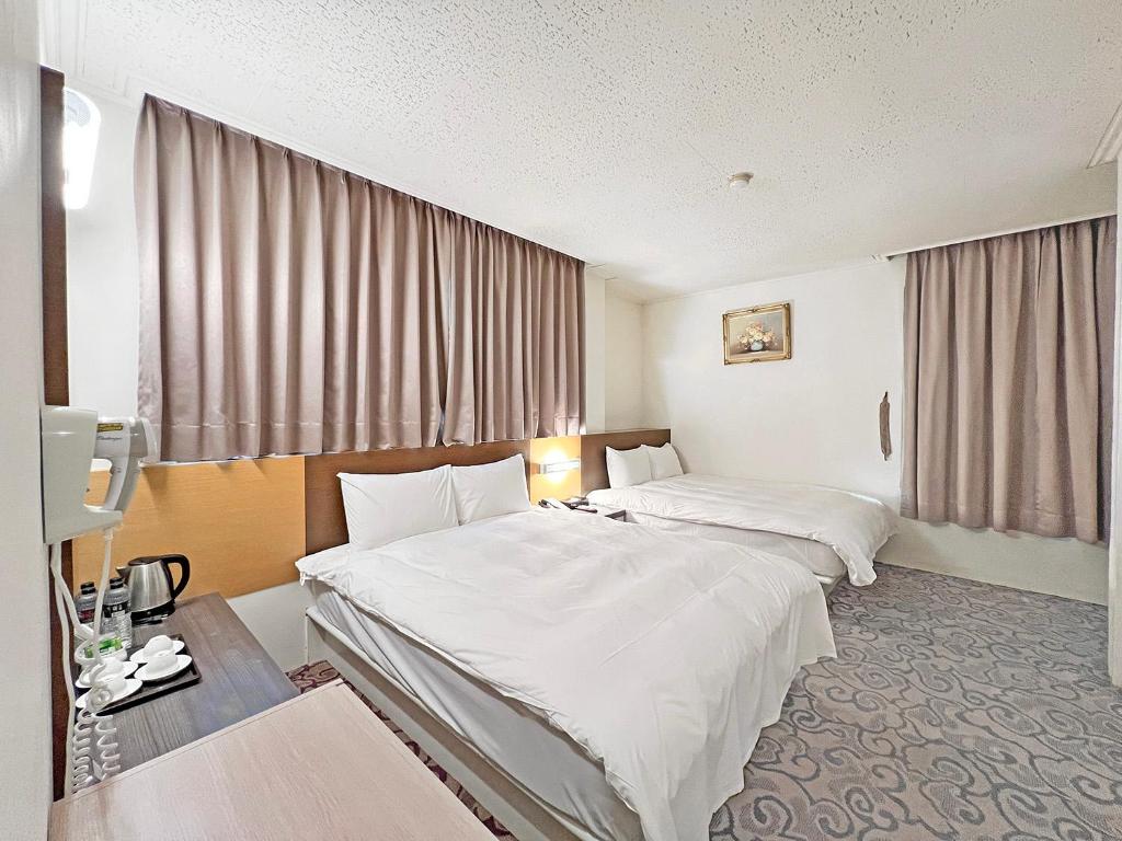 Postel nebo postele na pokoji v ubytování Foung Kou Hotel