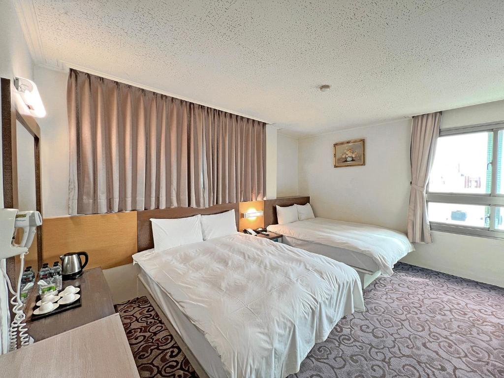 Postel nebo postele na pokoji v ubytování Foung Kou Hotel