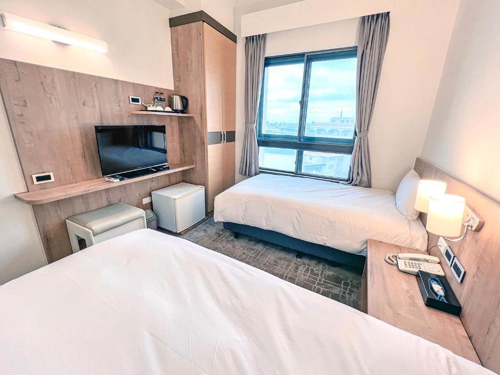 Postel nebo postele na pokoji v ubytování Foung Kou Hotel