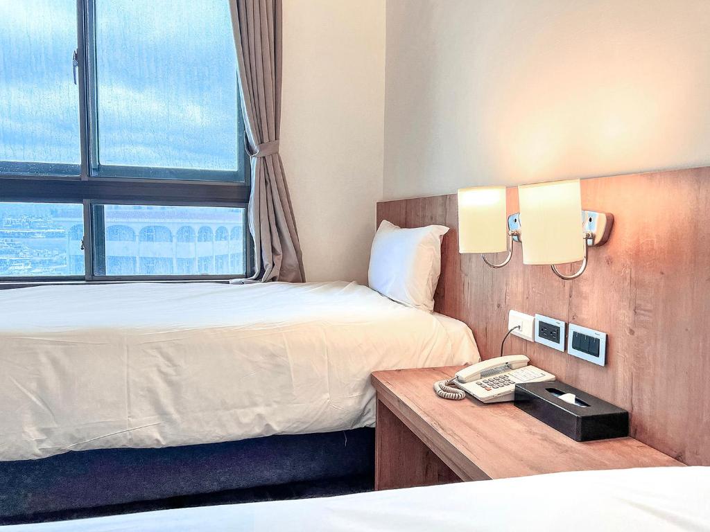 Postel nebo postele na pokoji v ubytování Foung Kou Hotel