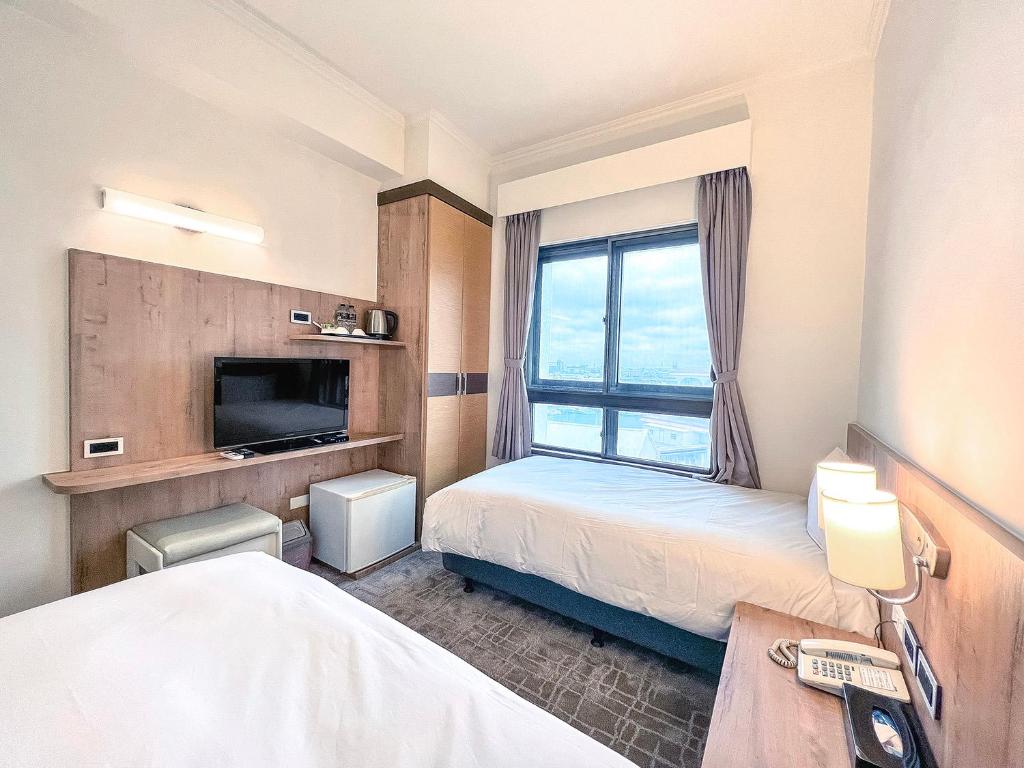 Postel nebo postele na pokoji v ubytování Foung Kou Hotel