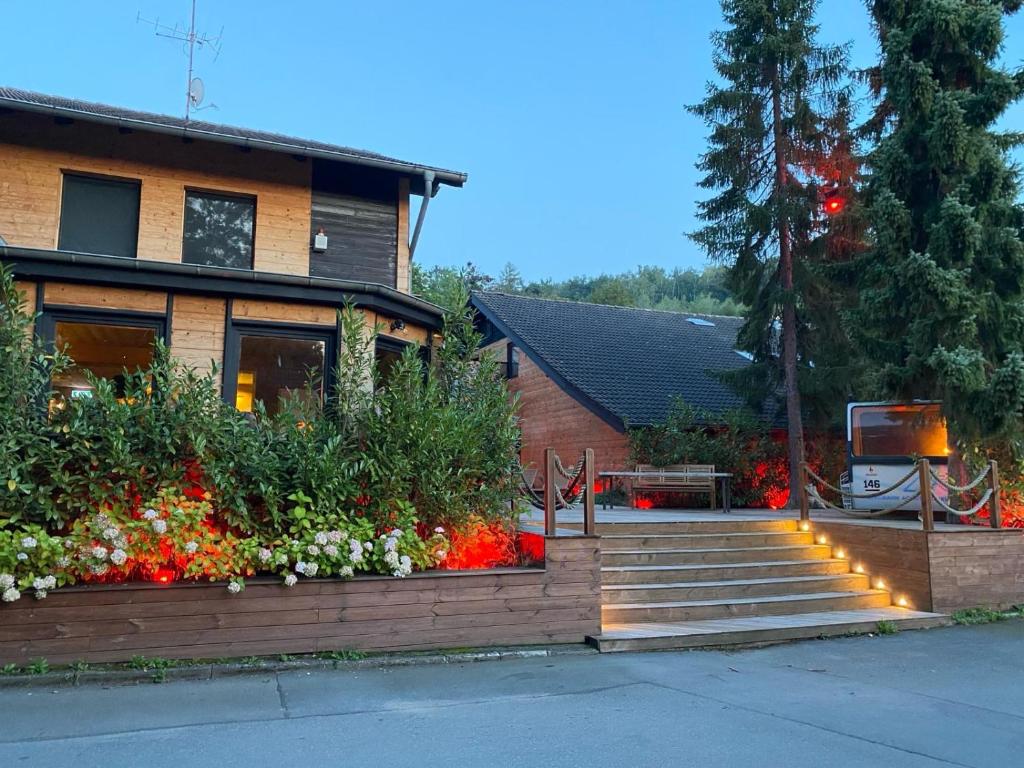 a house with a bunch of flowers in the yard at Wolfstein - Le Boutique Hotel in Bad Harzburg