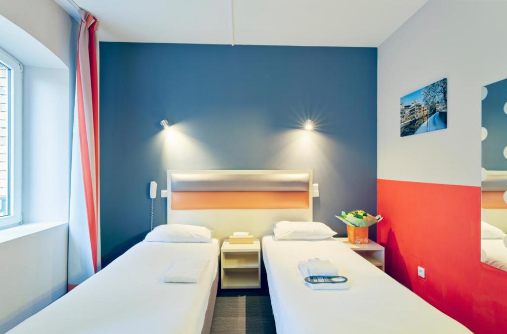 Postel nebo postele na pokoji v ubytování Adonis Hotel Strasbourg