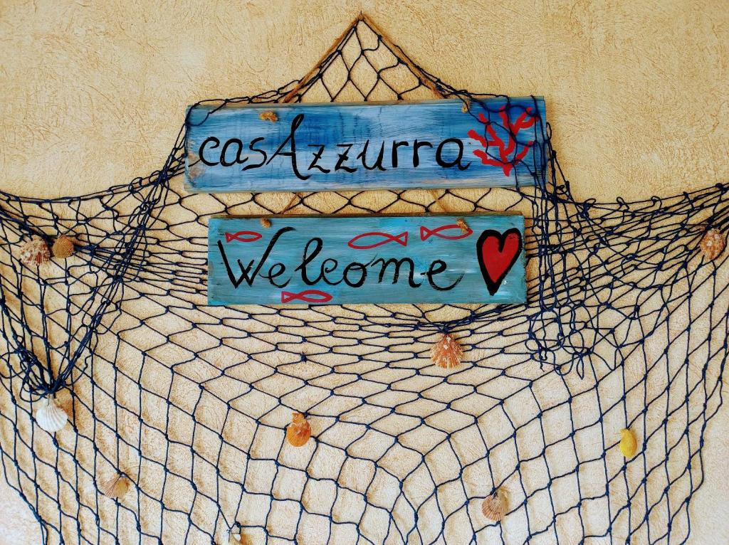 una señal que dice como una futura bienvenida en una cama en Casa Azzurra, en Capitana