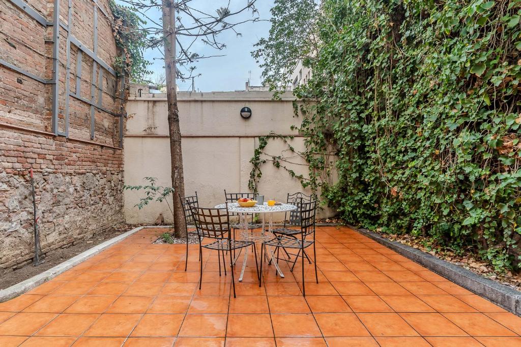 a table and chairs sitting on a patio at AB Passeig de Gràcia Còrsega in Barcelona