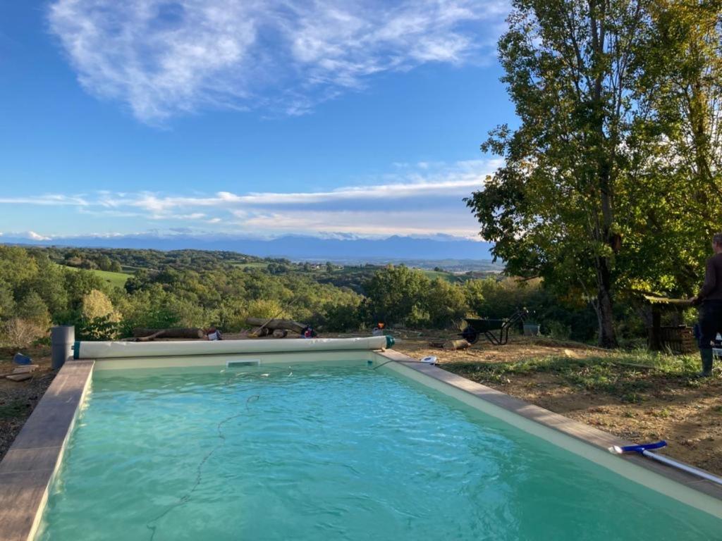 a swimming pool with a view of the countryside at La Toumet in Malabat