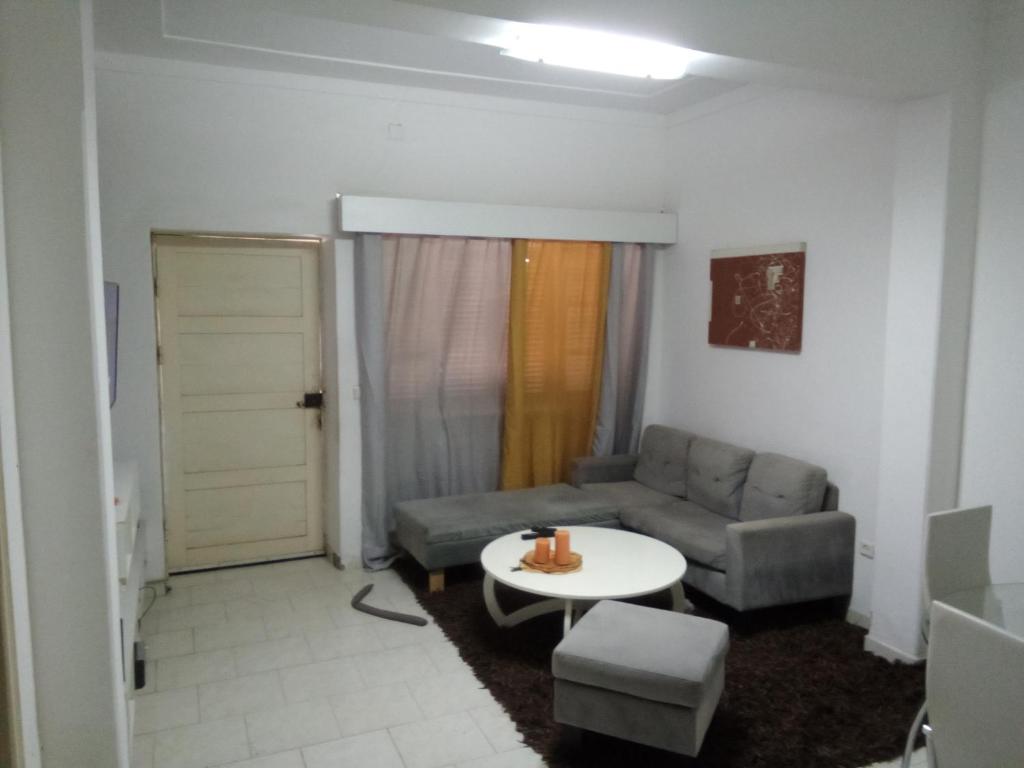 a living room with a couch and a table at Borges Place in Praia
