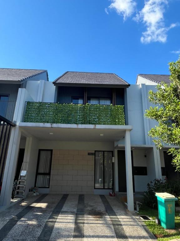 a house with a balcony on top of it at 2 Floor Cozy House in Wisteria Jakarta Garden City in Jakarta