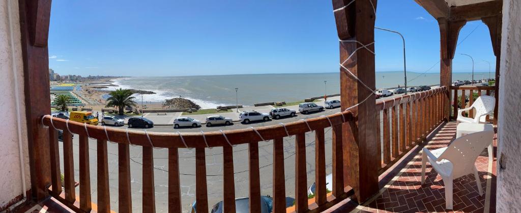 a balcony with a view of a beach with cars parked at Hotel con Hermosa Vista al Mar MDQ in Mar del Plata