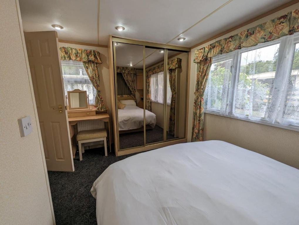 a bedroom with a bed and a mirror at The Senator 69 in Dunoon
