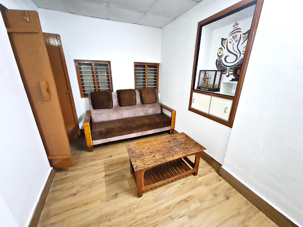 a living room with a couch and a table at Hallimane Homestay in Udupi