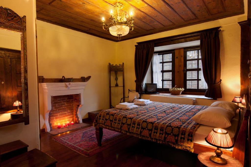 a bedroom with a bed and a fireplace at Vergoula's Mansion in Kastoria