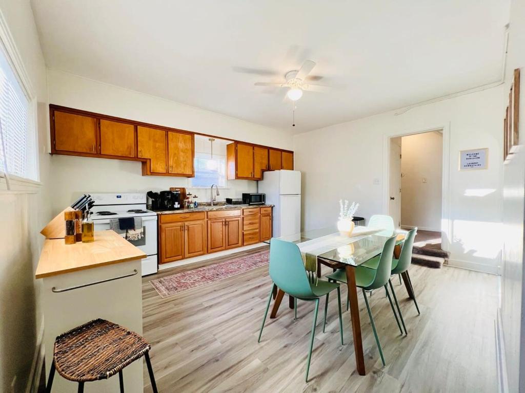 a kitchen with a table and chairs in a room at Botanical Bungalow in Greensburg in Greensburg