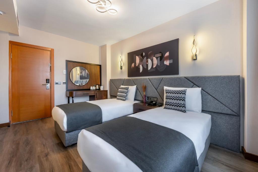 Postel nebo postele na pokoji v ubytování Hotel Bristol