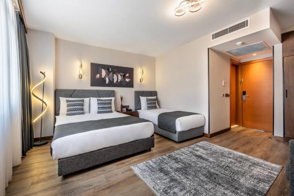 Postel nebo postele na pokoji v ubytování Hotel Bristol