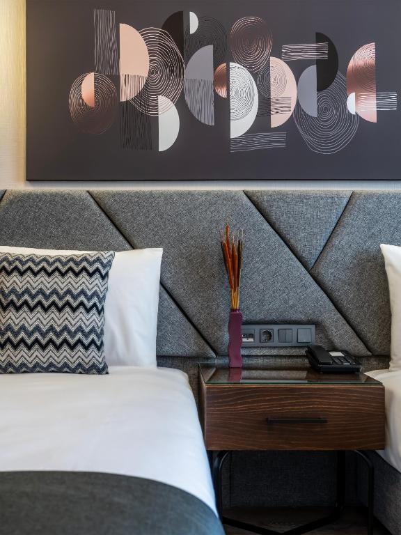 Postel nebo postele na pokoji v ubytování Hotel Bristol