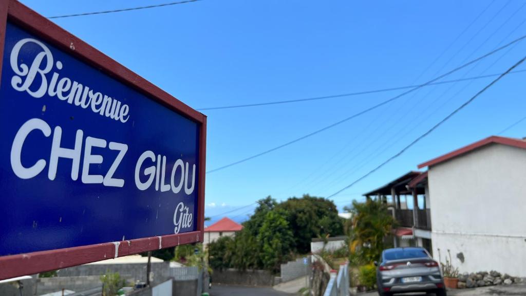 a blue sign that reads chez clov at Chez Gilou in Rivière