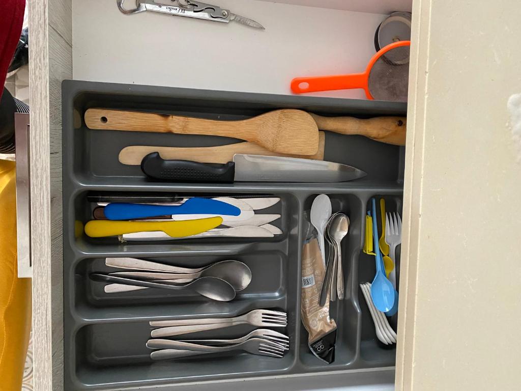 a drawer filled with lots of utensils at Beach House Málaga in Málaga