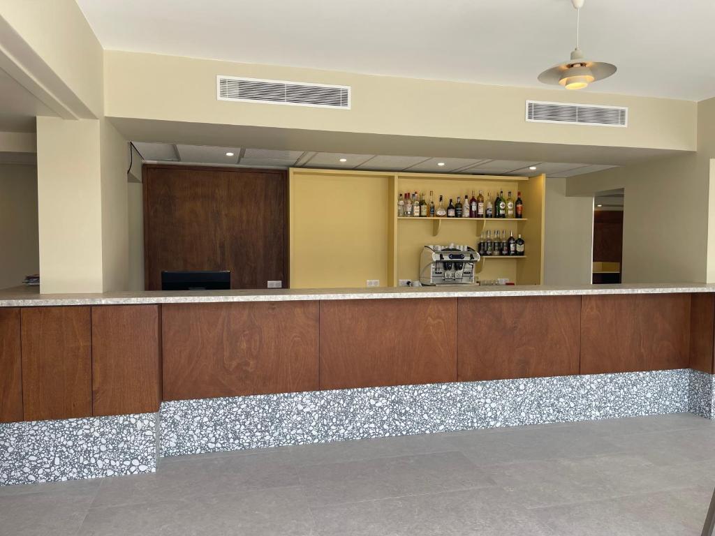 a large lobby with a bar in a building at Hotel des Victoires - Restaurant in Cannes