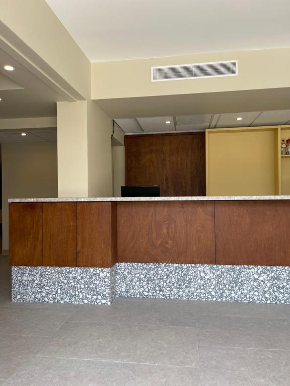 a lobby with a reception desk in a building at Hotel des Victoires - Restaurant in Cannes