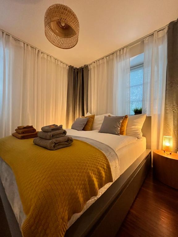 a bedroom with a large bed with white curtains at Apartment M4 in Salzburg