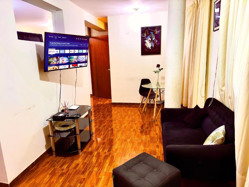 a living room with a couch and a flat screen tv at 200. Hermoso Departamento con Servicios Incluidos en Chorrillos in Lima