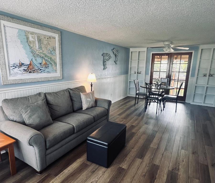 a living room with a couch and a table at River Wilderness Waterfront Cabins in Everglades City