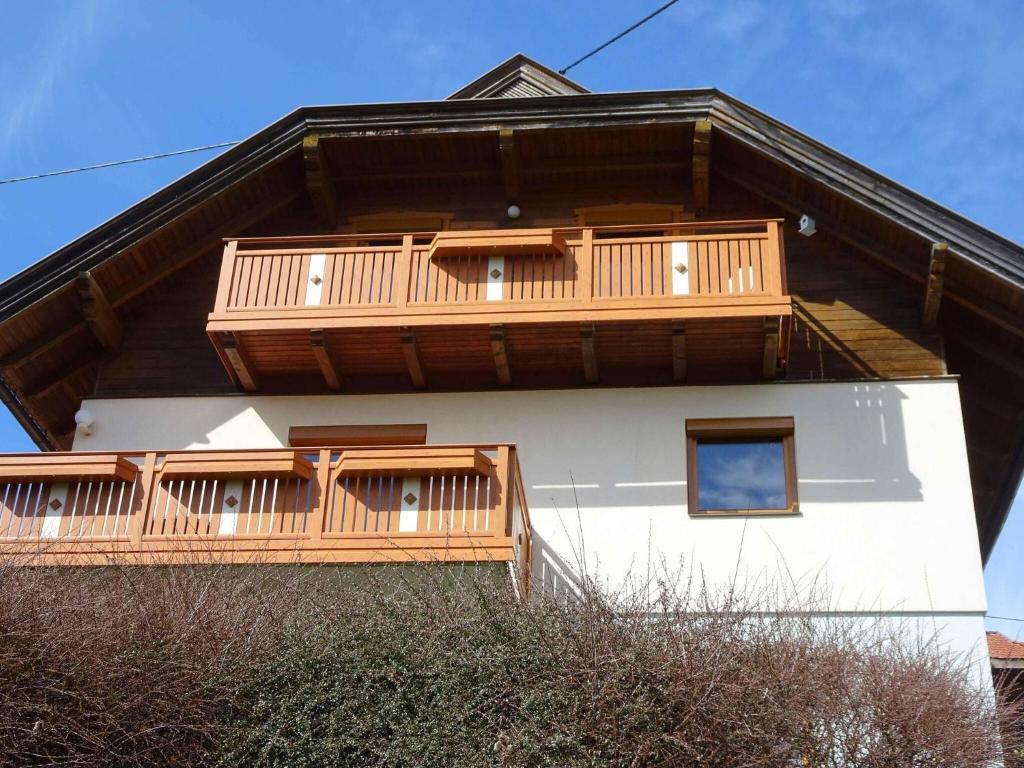 a house with wooden balconies on the side of it at Chalet in Diex near Klopeiner See with sauna in Diex