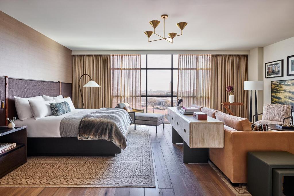 a hotel room with a bed and a couch at Bowie House, Auberge Resorts Collection in Fort Worth