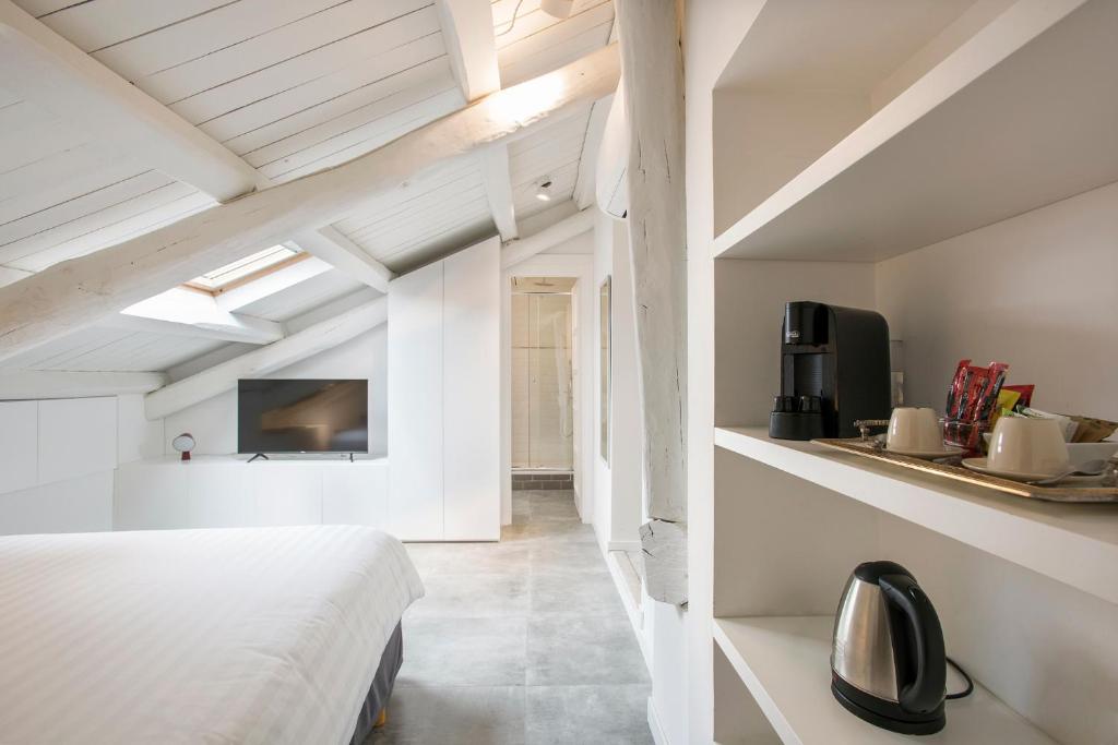 a bedroom with a bed and a tv on a wall at Gonfalone 6 in Rome