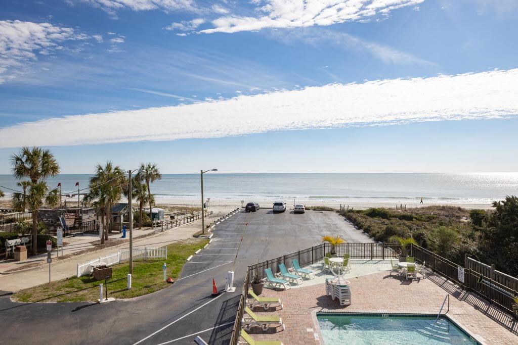 a view of the beach from the balcony of a resort at The Mermaid Inn in Myrtle Beach