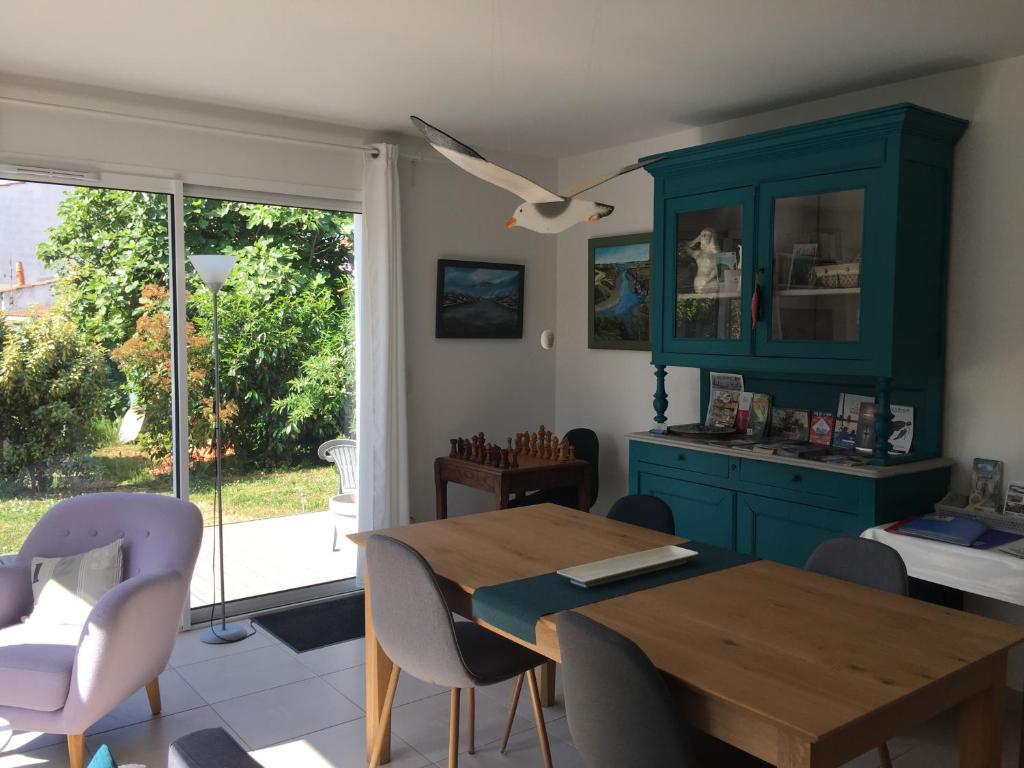 a dining room with a table and chairs and a window at 33 Bis in La Rochelle