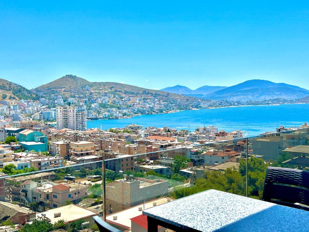 a view of a city with the water and mountains at Apartments Klajdi in Sarandë