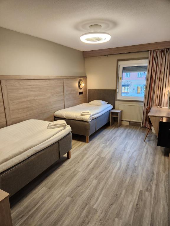 Postel nebo postele na pokoji v ubytování Hotell Stinsen