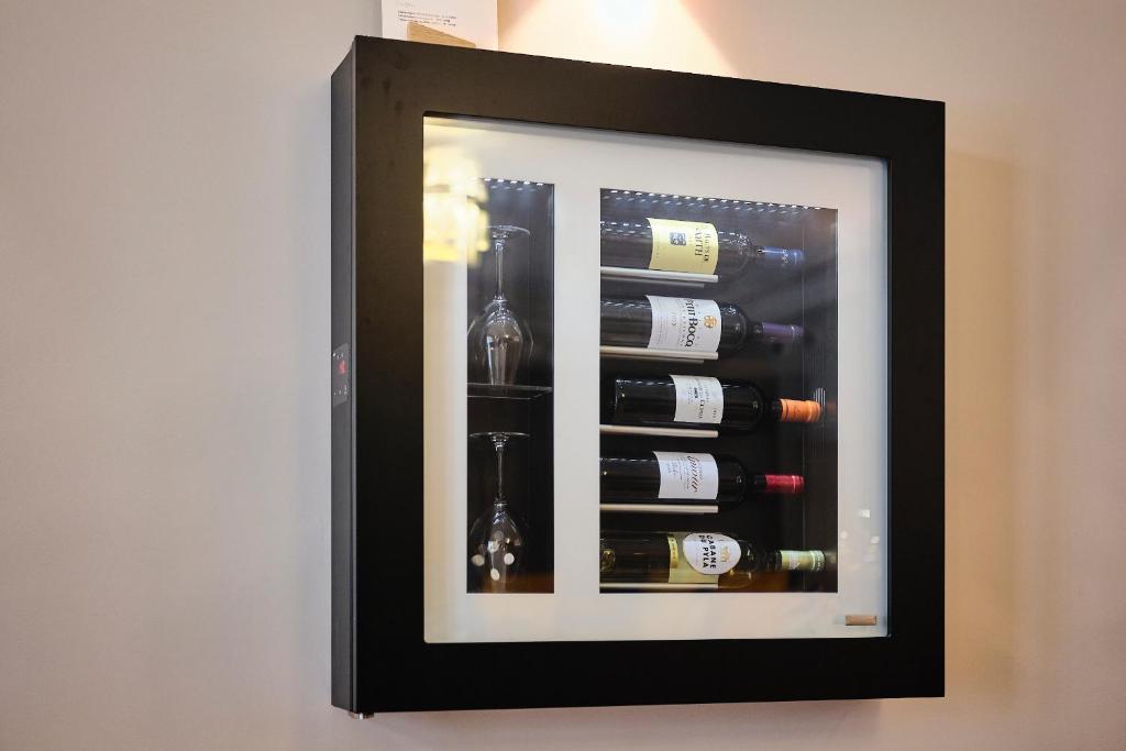 a framed picture of a wine cellar with wine bottles at Maison Heym Bordeaux in Bordeaux