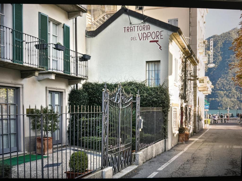 a gate in front of a white building at Cernobbio lake suites in Cernobbio