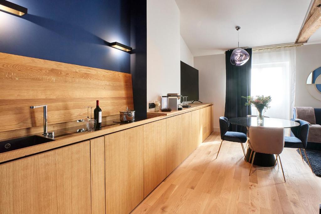 a kitchen with a counter with a sink and a table at Maison Heym Bordeaux in Bordeaux