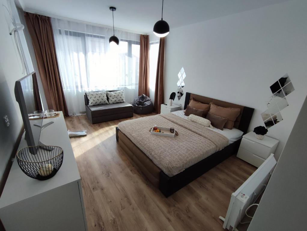 a bedroom with a bed and a couch in it at Summer day Chernomorets in Chernomorets