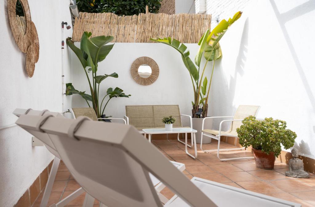 a balcony with chairs and plants in a room at Stylish Apartment with Terrace for Couple or Family in Barcelona