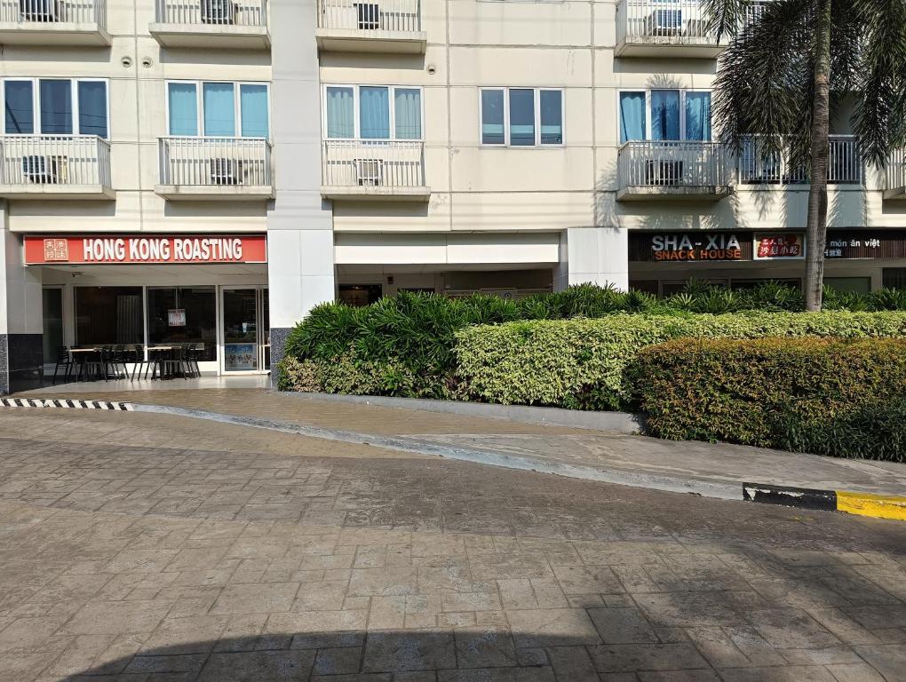 an empty street in front of a building at Sea Residences MOA -PaulJade Place in Manila