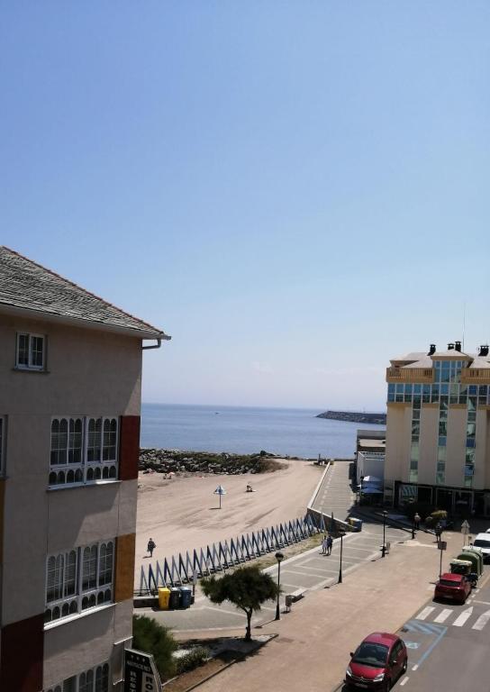 a view of a beach from a building at Apartamentos Rompeolas in Burela de Cabo